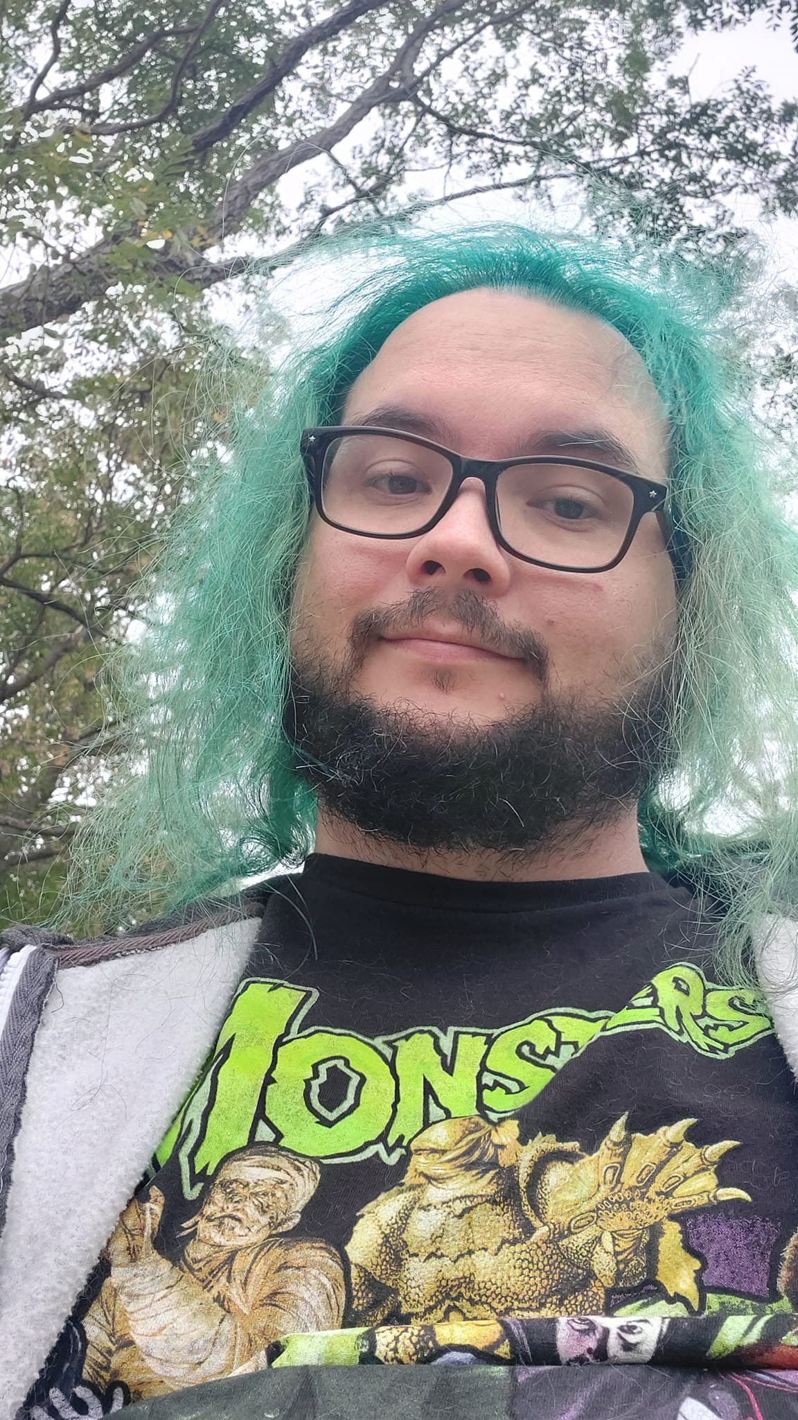 A man with green hair stands outside, photo 2